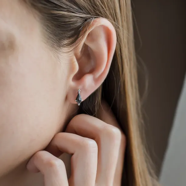 Gold POE earring with kite salt and pepper diamond worn on the ear