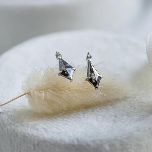 Gold POE earrings with kite salt and pepper diamonds in an angled view