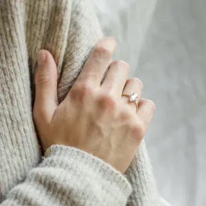 Gold SALEM ring with hexagon moissanite worn on a hand, close-up
