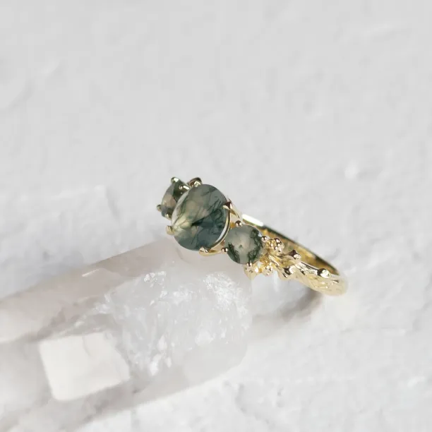 Gold BACCHUS ring with round green moss agate in an angled close-up