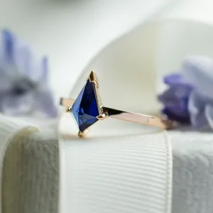 Angled close-up of the KODA gold ring with a blue lab-grown sapphire