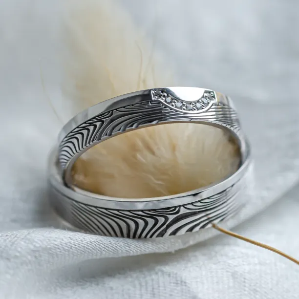 Wedding rings with abstract relief and diamonds OMEGA Image