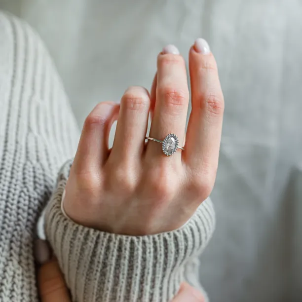 RIDLEY halo engagement ring worn on a hand