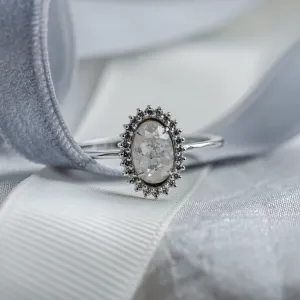 Close-up of the RIDLEY halo ring with a salt and pepper diamond