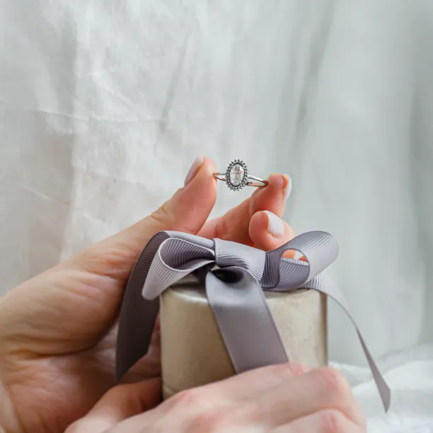RIDLEY salt and pepper diamond engagement ring held in a hand