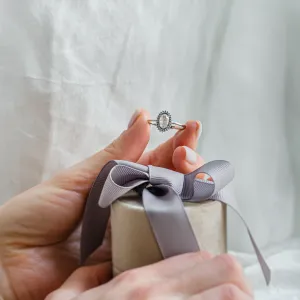 RIDLEY salt and pepper diamond engagement ring held in a hand