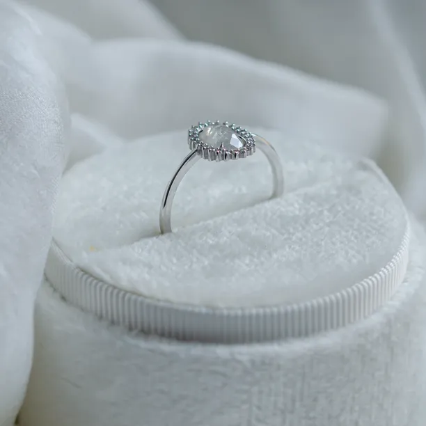 Side view of the RIDLEY halo engagement ring and oval diamond