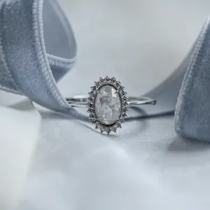 Close-up of the RIDLEY halo engagement ring with an oval salt and pepper diamond