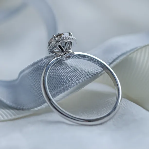 Angled detail of the TANAQUIL gold engagement ring with salt and pepper diamonds