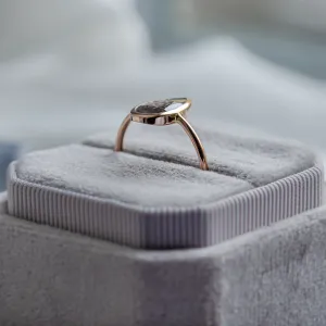 Angled view of the FLAVIA gold ring with a large salt and pepper diamond