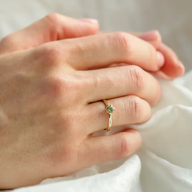 Minimalist moss agate ring worn on the hand