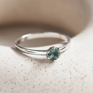 Angled close-up of the minimalist moss agate ring