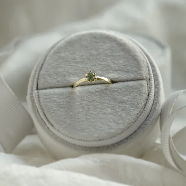 Minimalist moss agate ring displayed on a ring cushion