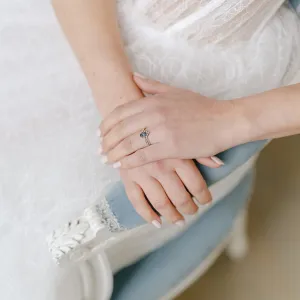 Gold ring with London blue topaz worn on the hand
