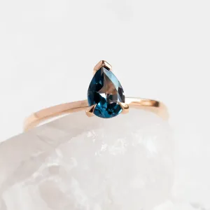 Close-up of a rose gold ring with London blue topaz