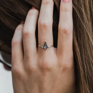 VALENTINO engagement ring with a kite-shaped salt'n'pepper diamond worn on a finger