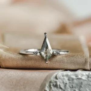 Close-up of the VALENTINO gold engagement ring with side diamonds and a salt'n'pepper diamond