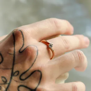 Gold engagement ring with lab-grown diamond worn on a hand