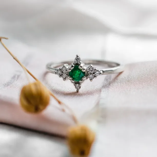 Gold emerald ring with diamonds, clear close-up view