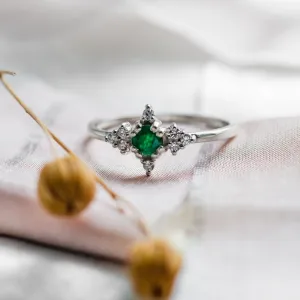Gold emerald ring with diamonds, clear close-up view