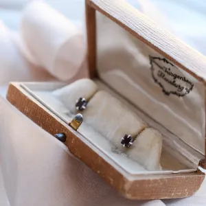 GARNI gold garnet earrings displayed in an open jewelry box
