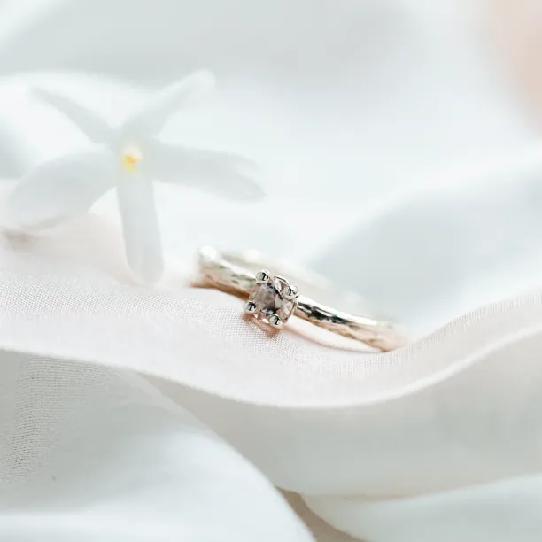 Angled close-up of the gold branch ring with morganite