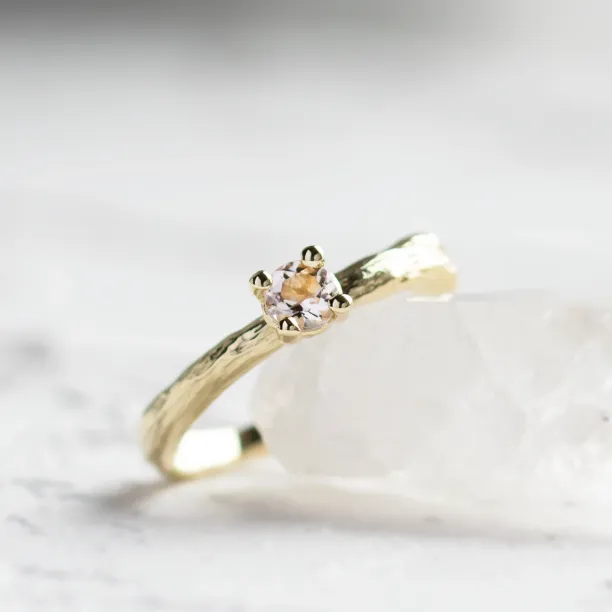 Close-up of the morganite and textured branch band on a gold ring