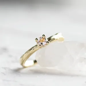 Close-up of the morganite and textured branch band on a gold ring