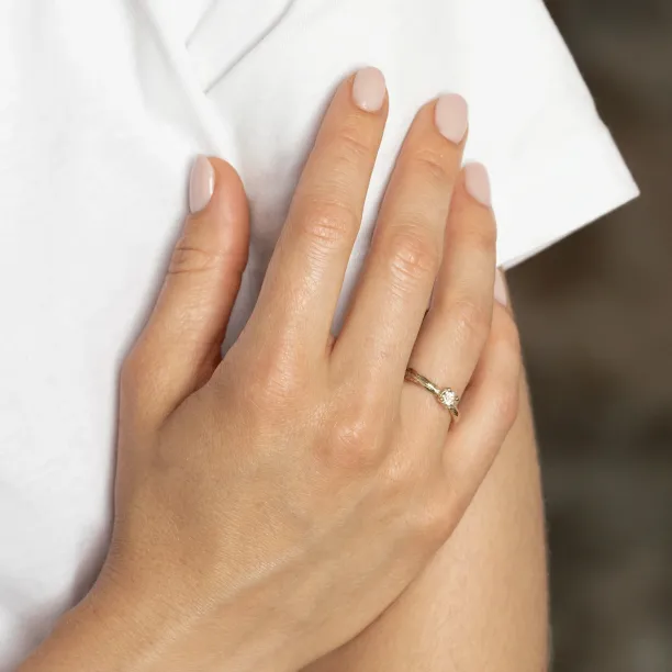 Gold branch ring with morganite worn on the hand, wider view