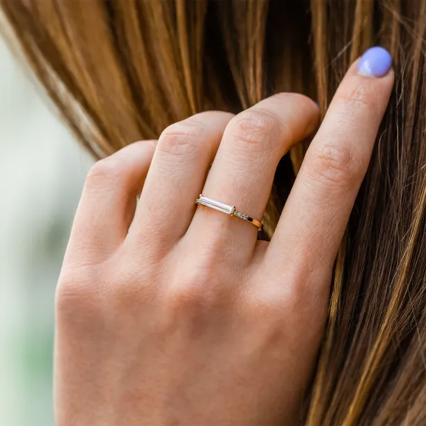 CASSIA engagement ring with baguette moissanite and diamonds worn on a hand