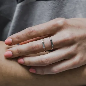 Two CASSIA engagement rings with baguette moissanite worn on adjacent fingers