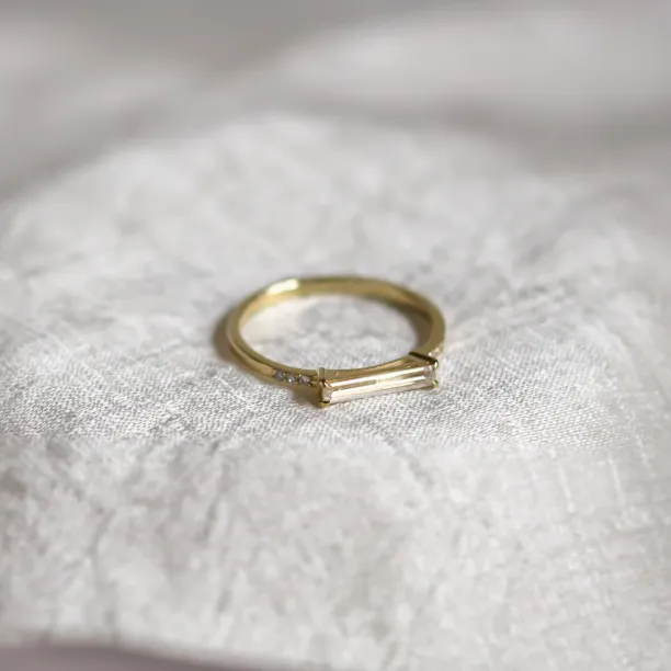 CASSIA engagement ring with baguette moissanite and diamonds, angled view