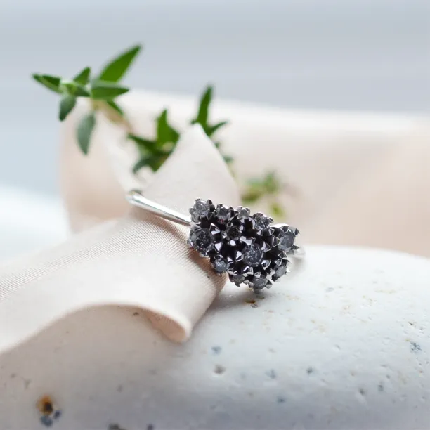 Angled view of the SEVERINOS gold cluster ring with salt and pepper diamonds