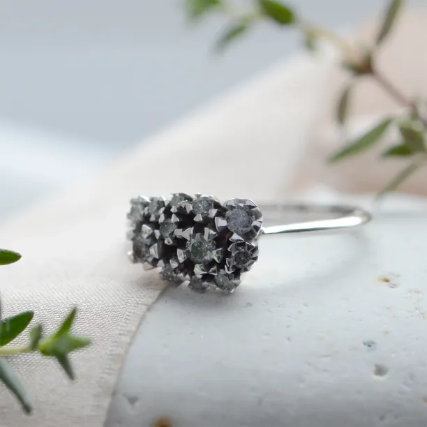 Angled close-up of the SEVERINOS gold cluster ring with salt and pepper diamonds