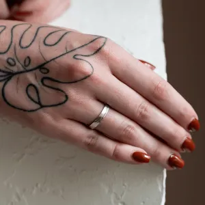LIDO gold wedding ring with a line worn on a hand