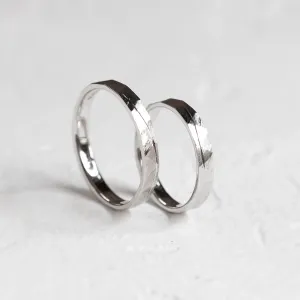 Gold wedding rings standing together with hammered surface and line