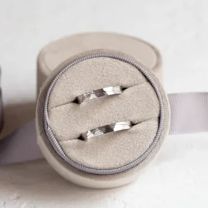 Pair of gold wedding rings displayed in a ring box