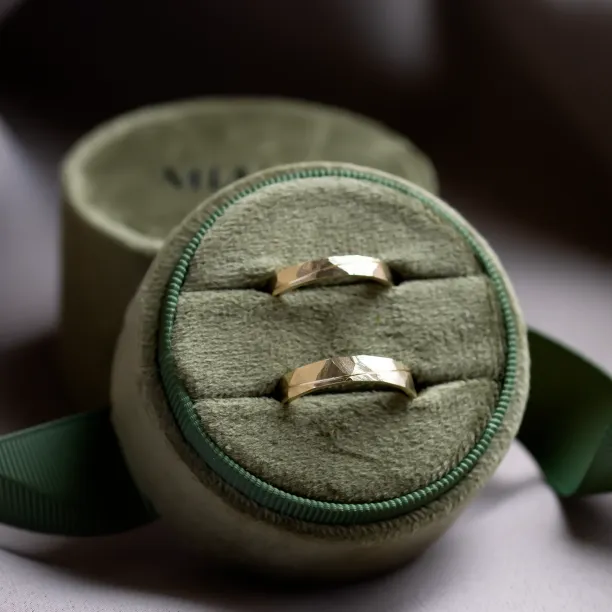 Pair of gold wedding rings displayed in a ring box