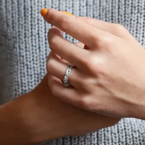 SELENE space moon wedding band worn on a hand, showing crater-like perforations