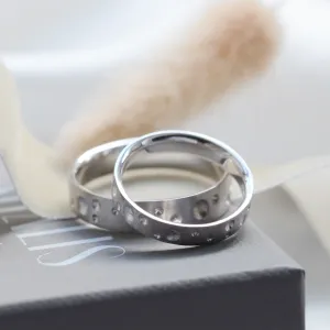 Pair of SELENE wedding bands with crater-like perforations