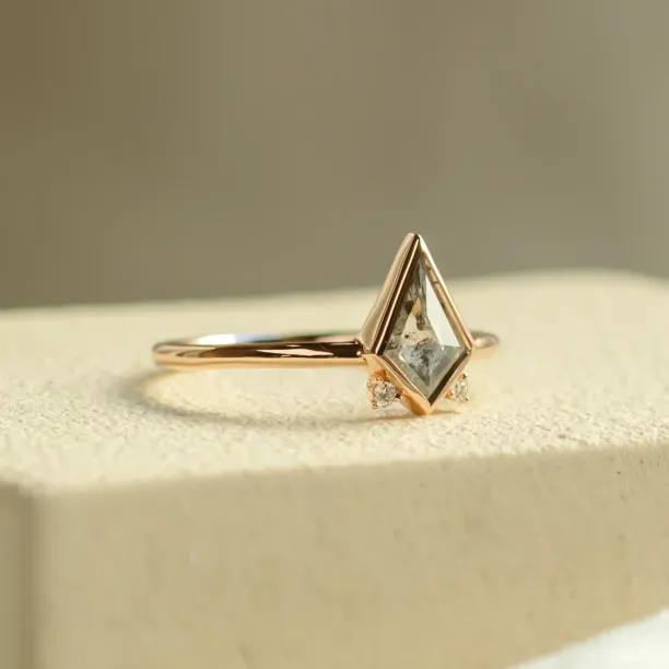 Angled view of the CATKIN gold ring with kite salt and pepper diamond and side diamonds