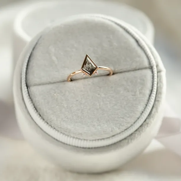Close-up of the CATKIN gold ring with kite salt and pepper diamond and side diamonds