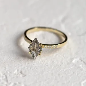 Angled view of ESTER gold ring with kite rutilated quartz and diamond-set band