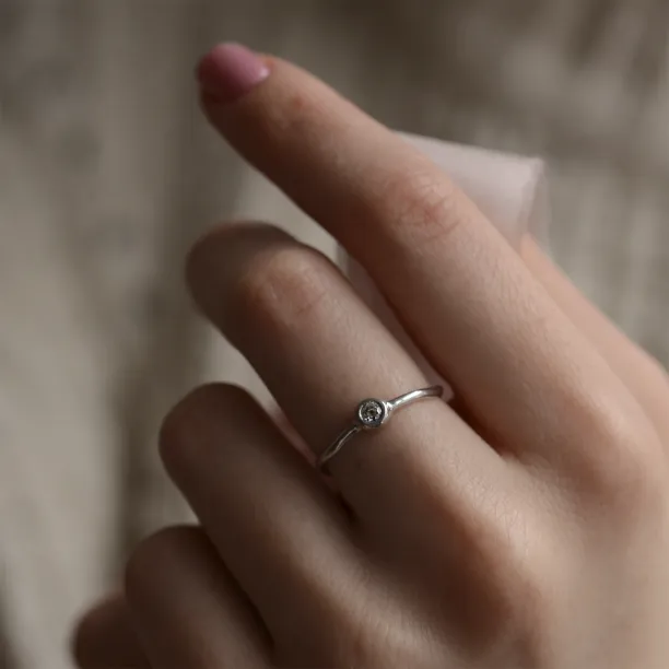 NOLLAIG diamond engagement ring worn on a hand