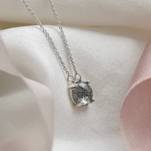 Angled view of the MACHA gold necklace pendant with rose cut rutile quartz