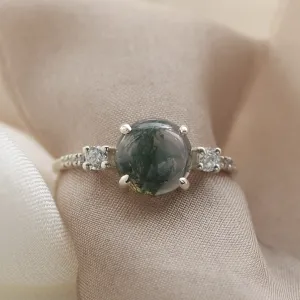 Close-up of the FIONNUALA ring showing its cabochon moss agate and diamonds