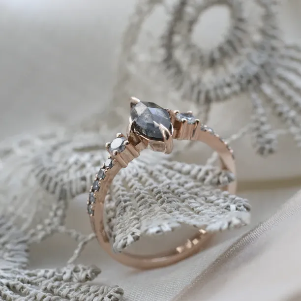 Angled close-up of the ROISIN ring showing its marquise diamond and detailed setting