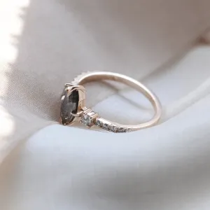 Angled close-up of the vintage gold ROISIN ring with a marquise salt and pepper diamond