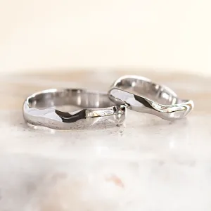 Close-up of LUANA white gold wedding rings with irregular surfaces