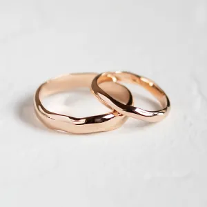 Angled view of LUANA rose gold wedding rings